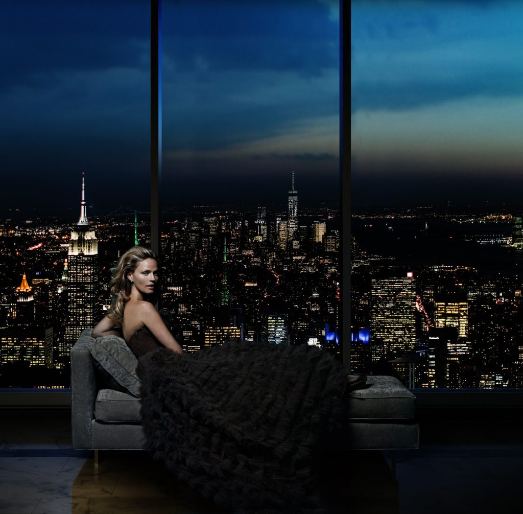 CGI rendering of Central Park Tower interior showing view at night through floor-to-ceiling windows